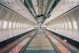 A Boeing 727 has been stripped of its interiors while its seats undergo maintenance and their covers are replaced. From the series "The LAB Project" © Nick Ballon.
