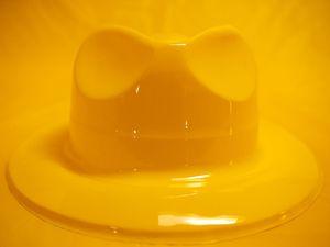 Yellow plastic fedora and yellow plastic tablecloth